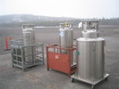 Two empty nitrogen dewars and a helium dewar being stored outside.